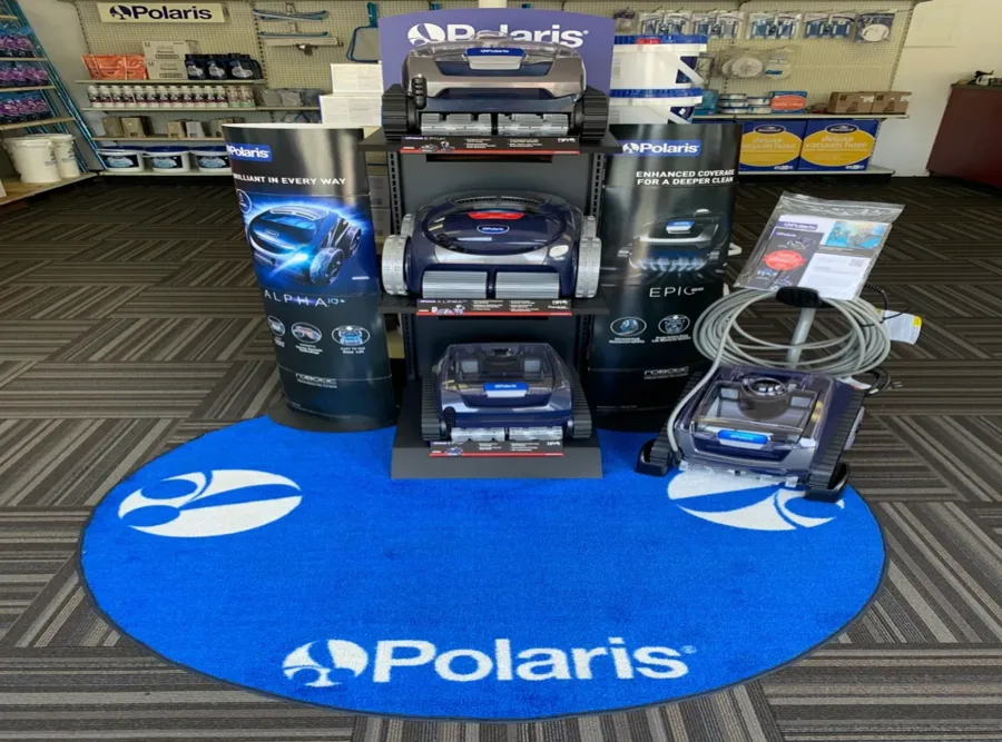 Polaris robotic pool cleaners on display on a blue Polaris rug